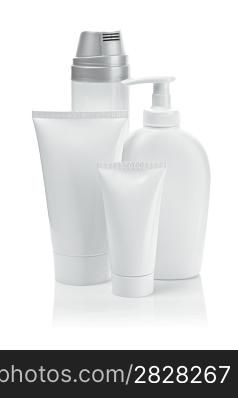 white cosmetical tubes and spray bottles