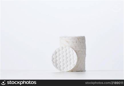 White cotton sponges on a white background. Design for the beauty, medicine and cosmetics industry, copy space