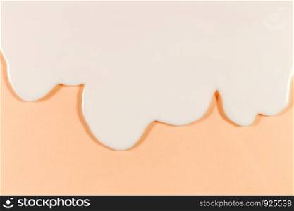 White cream flow on the soft orange background.