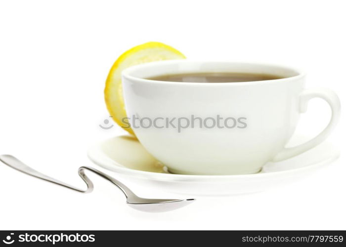 white cup, a spoon and a lemon isolated on white