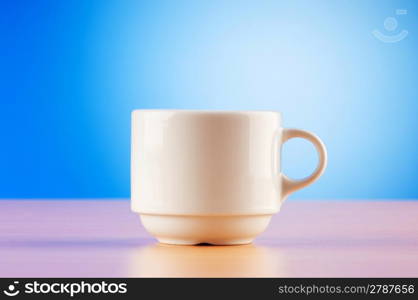 White cup against colourful gradient on the table