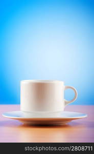 White cup against colourful gradient on the table