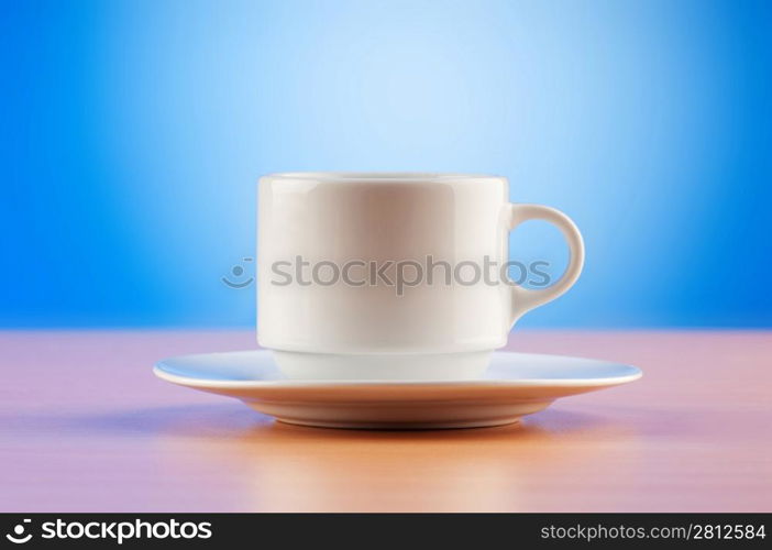 White cup against colourful gradient on the table