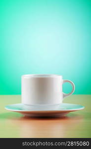 White cup against colourful gradient on the table