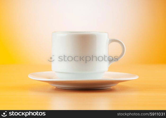 White cup against colourful gradient on the table