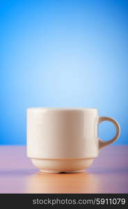 White cup against colourful gradient on the table