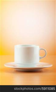 White cup against colourful gradient on the table