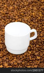 White cup and background of coffee beans