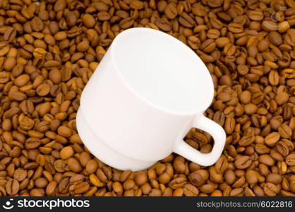 White cup and background of coffee beans