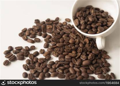 white cup filled with coffee beans. High resolution photo. white cup filled with coffee beans. High quality photo