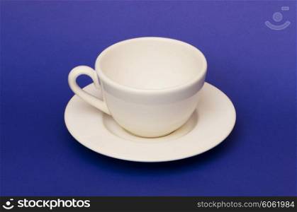 White cup isolated on the blue background