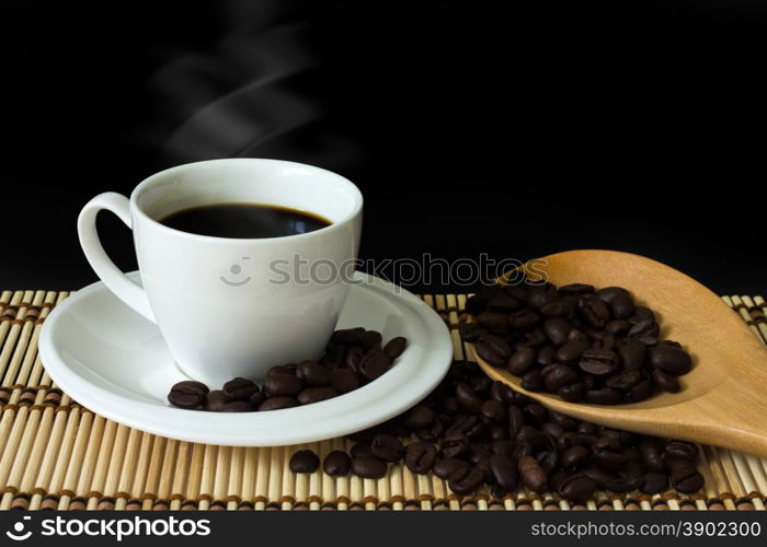 white cup of coffee on black background