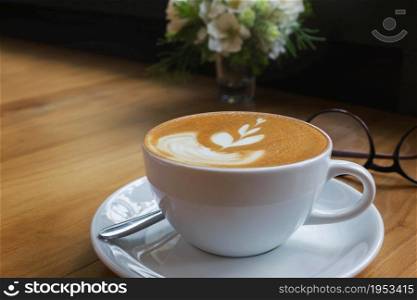 White Cup Of Coffee On Wooden Table In Vintage Color Mood.