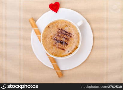 White cup of hot beverage drink coffee cappuccino latte with froth, sweet waffle roll stick with cream and red heart love symbol. Valentine&#39;s day. Studio shot.