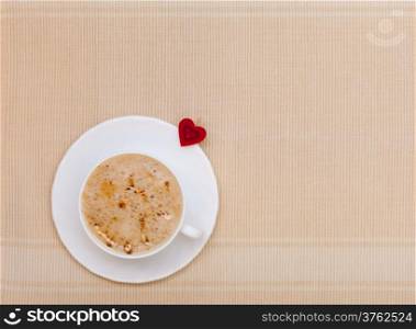 White cup of hot beverage drink coffee cappuccino latte with heart shape symbol love. Valentine&#39;s day.