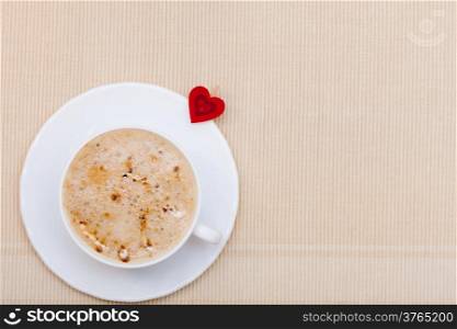 White cup of hot beverage drink coffee cappuccino latte with heart shape symbol love. Valentine&#39;s day.