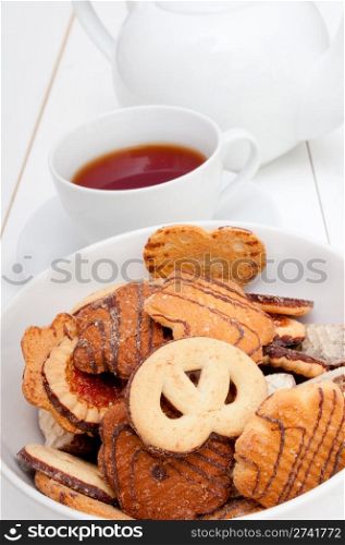 White Cup of Tea, Biscuits and Teapot on White Table