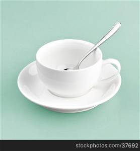 white cup on green blue background