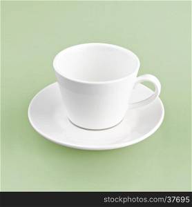 white cup on green yellow background