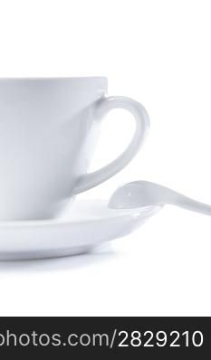 white cup on saucer with spoon isolated