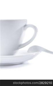 white cup on saucer with spoon isolated