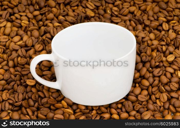 White cup on the background of coffee beans