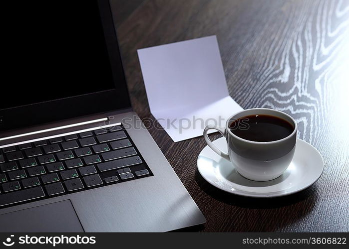 White cup with black coffee at business workplace