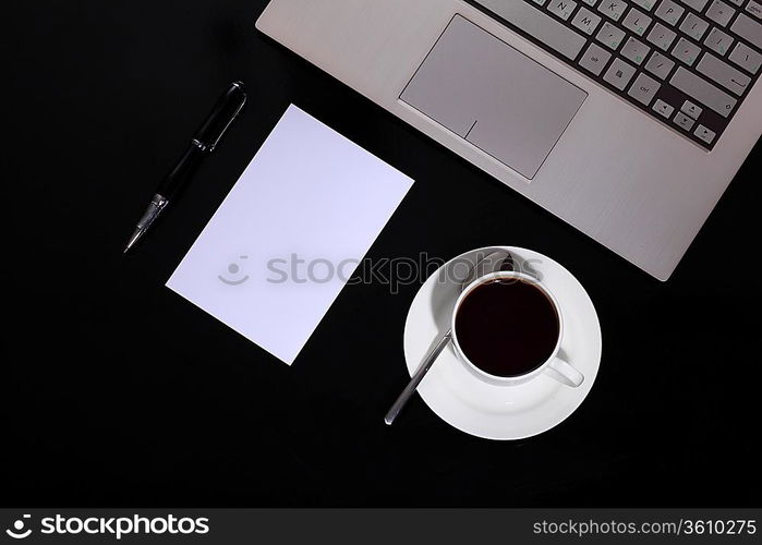 White cup with black coffee at business workplace