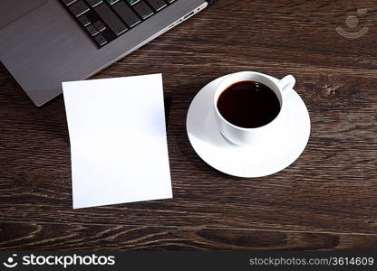 White cup with black coffee at business workplace