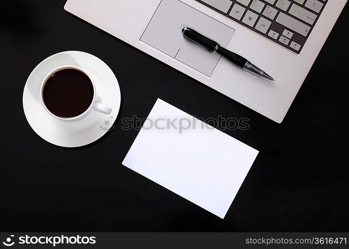 White cup with black coffee at business workplace