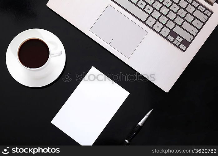 White cup with black coffee at business workplace