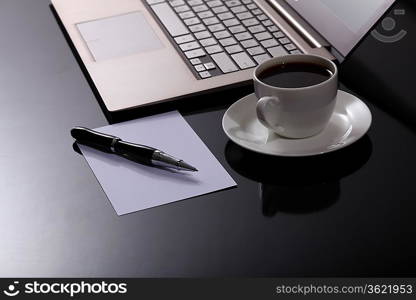 White cup with black coffee at business workplace