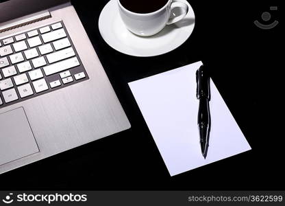 White cup with black coffee at business workplace