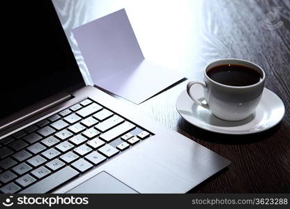 White cup with black coffee at business workplace