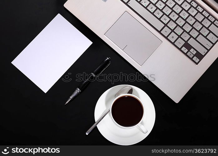 White cup with black coffee at business workplace