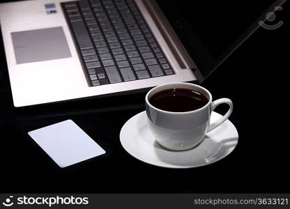 White cup with black coffee at business workplace