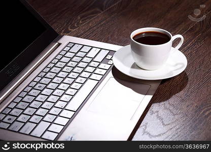 White cup with black coffee at business workplace