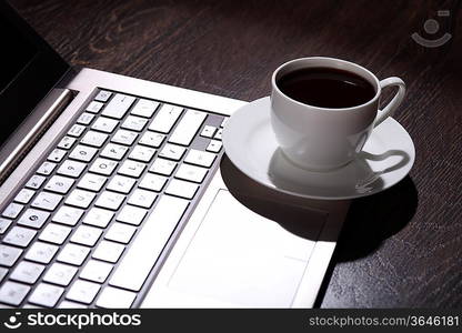 White cup with black coffee at business workplace