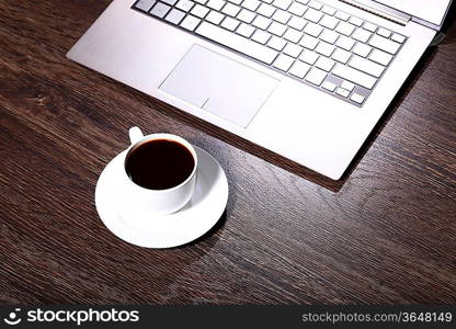 White cup with black coffee at business workplace