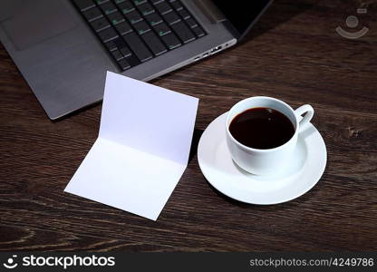 White cup with black coffee at business workplace