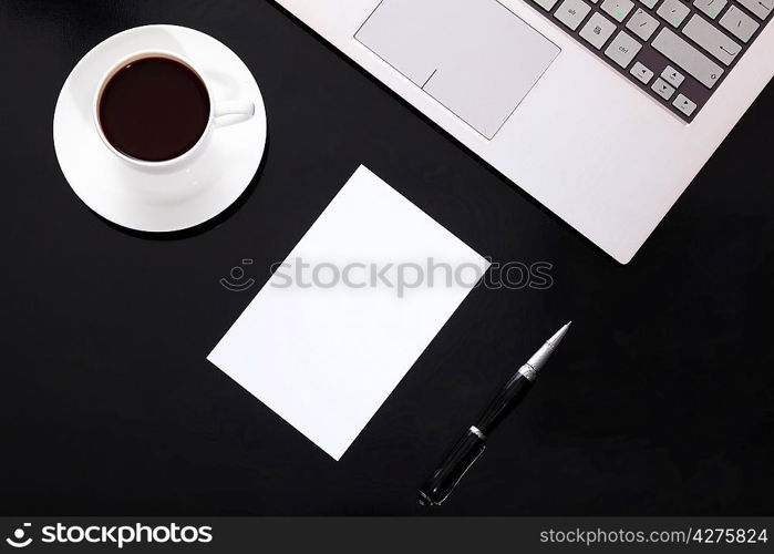 White cup with black coffee at business workplace