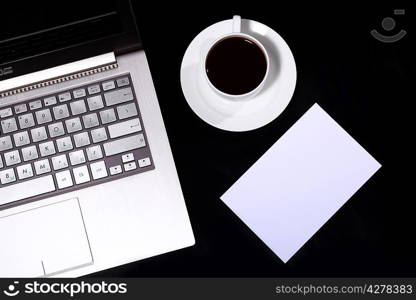 White cup with black coffee at business workplace