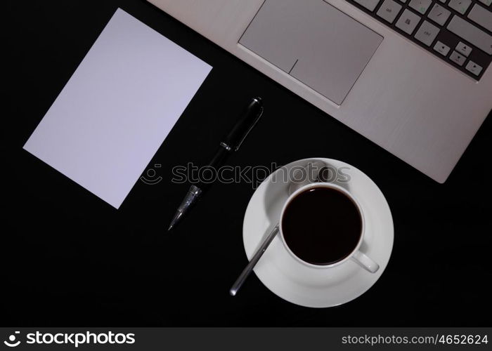 White cup with black coffee at business workplace