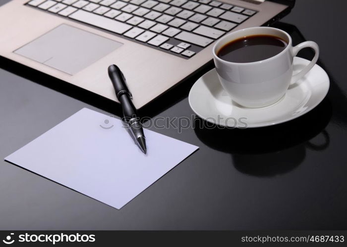 White cup with black coffee at business workplace