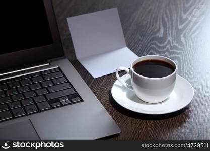 White cup with black coffee at business workplace