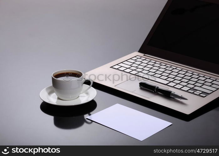 White cup with black coffee at business workplace