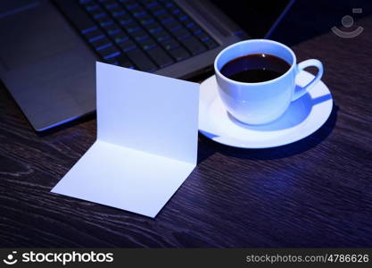 White cup with black coffee at business workplace