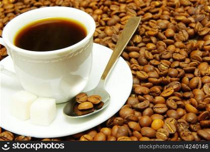 white cup with coffee costing on a coffee grain