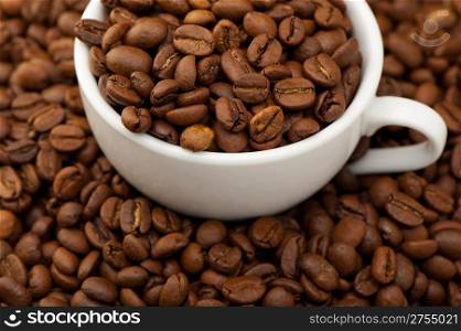 White cup with coffee grains. A photo close up