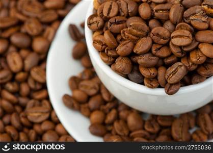 White cup with coffee grains. A photo close up
